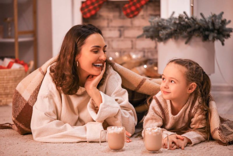 Mom and daughter drinking hot chocolate in cottage at Olema House