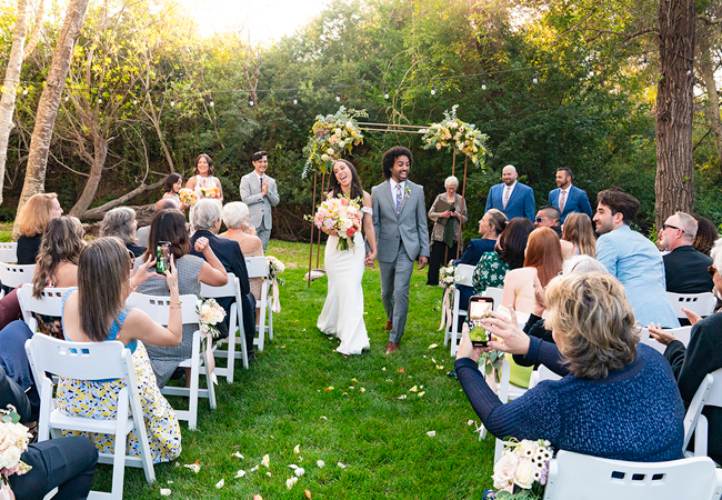 Couple walking down aisle on the lawn