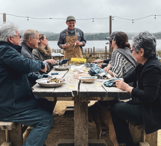 Tour group at Hog Island Oyster eating oysters with a guide